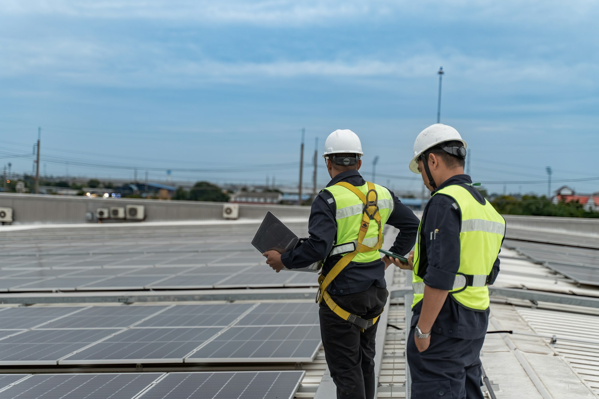 Black view of engineering on roof for check solar cell of factory.