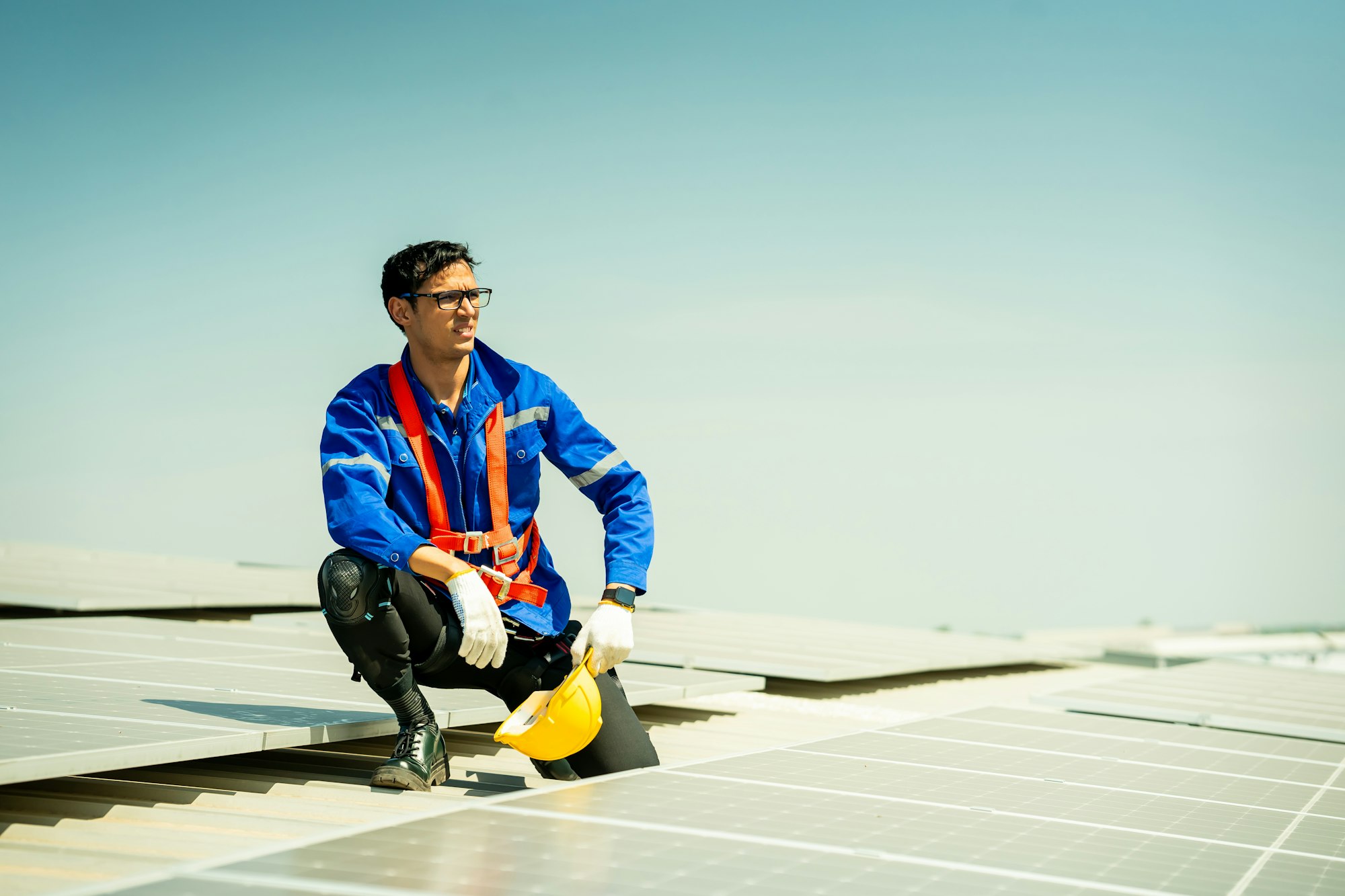 Engineer service check installation solar cell on the roof of factory.